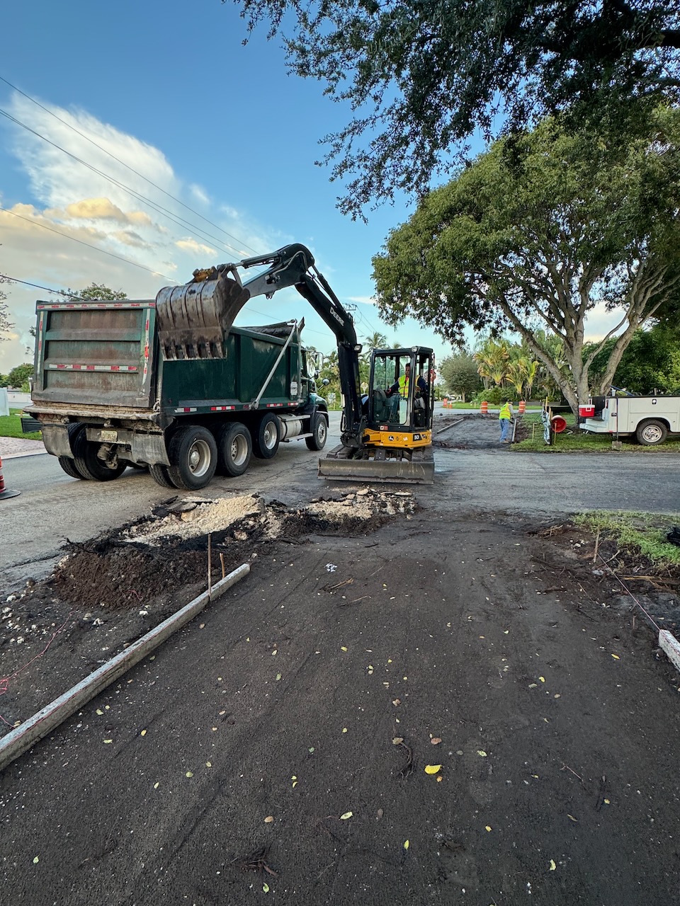 Excavator and dump truck preparing a roadway